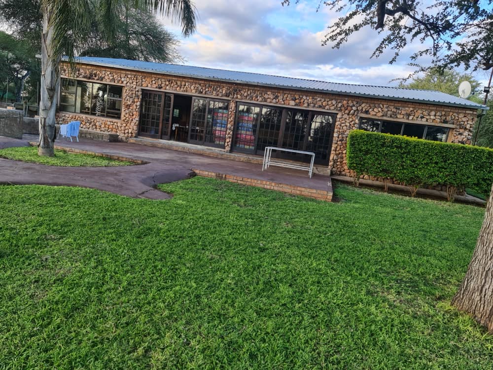 Maxi Ranch lodge exterior with stone walls and garden